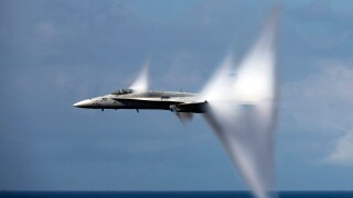 F/A-18C Hornet Jet airplane breaking the sound barrier.