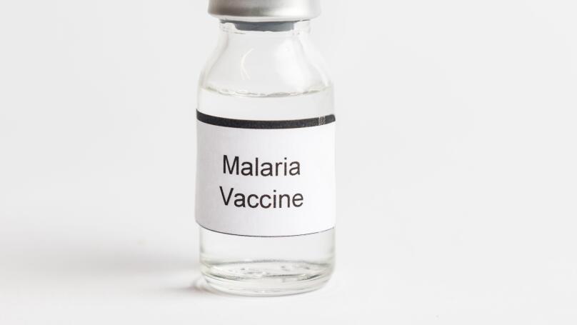 A Medical Vial with a label reading Malaria Vaccine