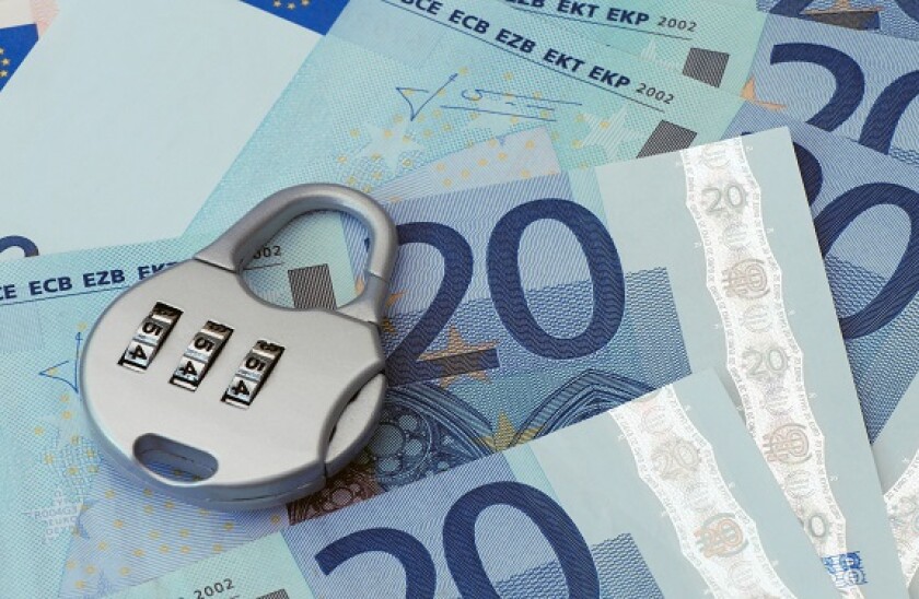 Combination padlock rests on Twenty Euro banknotes