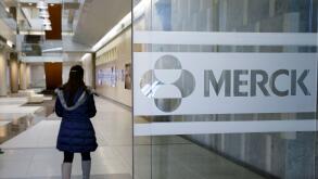 In this Thursday, Dec.18, 2014 photo, a person walks through a Merck & Co. building, in Kenilworth, N.J. Merck & Co. reports quarterly financial results before the market opens Tuesday, April 27, 2015. (AP Photo/Mel Evans)