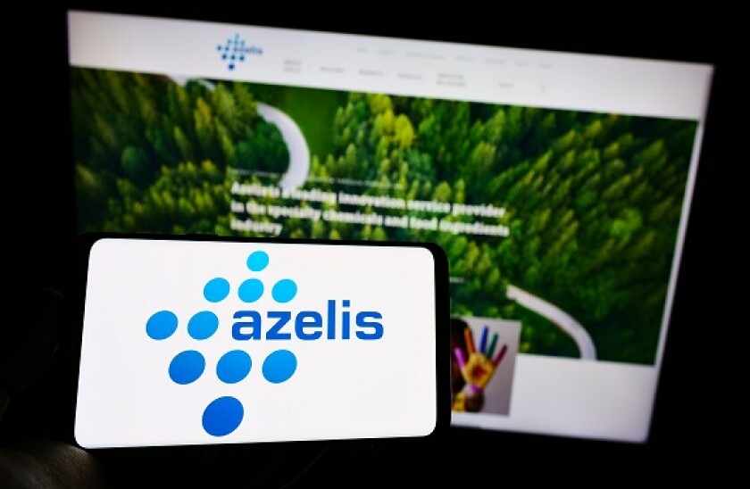 Person holding smartphone with logo of Belgian chemical company Azelis Holding S.A. on screen in front of website. Focus on phone display.