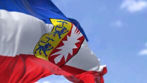 The flag of Schleswig-Holstein waving in the wind on a clear day