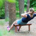 Woman doing abs workout in the forest.