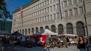 Swiss national bank in zurich with flea market in the foreground