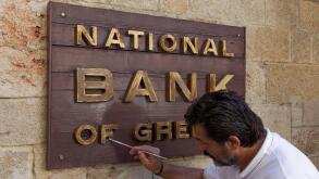 Sign "National Bank of Greece", man painting the sign, new town, Rhodes, Rhodos Island, Dodecanese, Greece