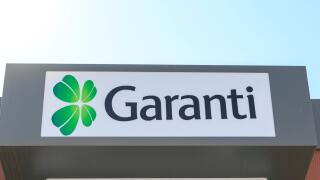 At Engin Boulevard Garanti bank atm i Marmaris, Turkey - June 24, 2018 :  The head of Garanti Bank with sky of Garanti ATM machine in Engin Boulevard