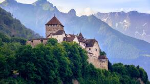 Vaduz Castle, the official residence of the Prince of Liechtenstein, with Alps mountains in background