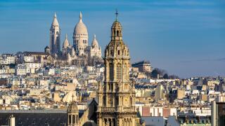 Rooftops of Paris with view of the Sacre Coeur Basilica in Montmartre and the Trinity Church. 18th Arrondissement, Paris, France