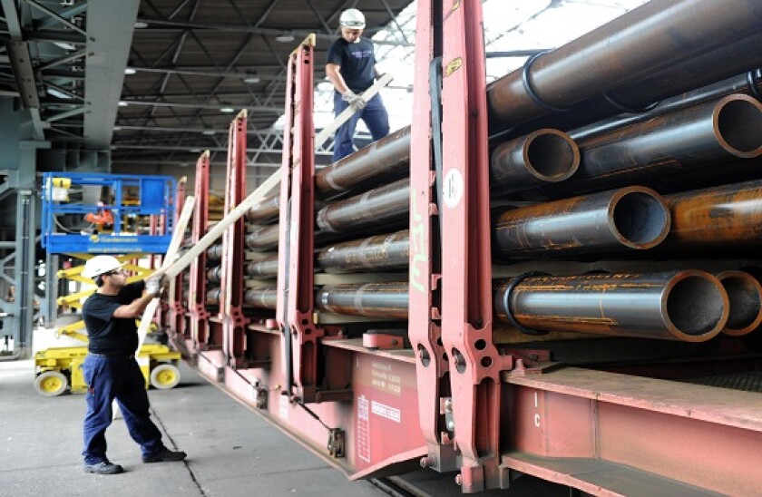 Employees stack steel pipes in the manufacturing hall at Vallourec and Mannesmann in Duesseldorf, Germany, 09 July 2013. Photo. Caroline Seidel