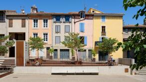 Colourful French houses beside the Cathedral Saint - Michel in Carcassonne, France.