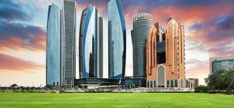 Skyscrapers in Abu Dhabi at dramatic sunset; United Arab Emirates