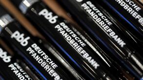 Pens printed with the writing 'Deutsche Pfandbriefbank' are seen during the financial statements press conference of Hypo Real Estate (HRE) in Munich, Germany, 01 March 2012. The commercial property lender presented its balance sheets of 2011. Photo: FRAN