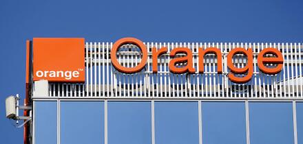 Bucharest, Romania - August 16, 2021: A logo of Orange, French telecommunications company, is displayed on the top of a building, in 'Pipera' neighbor