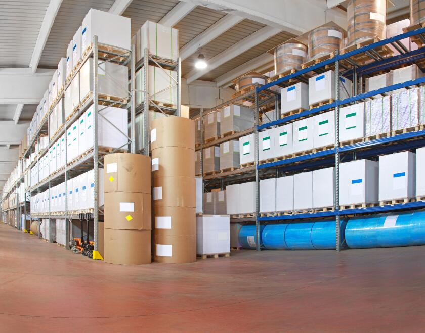 Distribution warehouse with paper rolls and material for printing