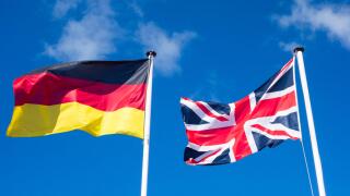 Flags of Germany and United Kingdom against blues sky