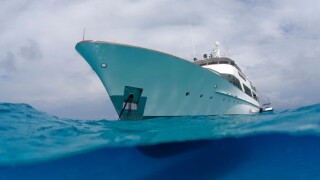 A split water view of a yacht in the Bahamas.