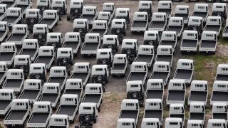 An aerial view of industrial light vehicles parked neatly in an open space.