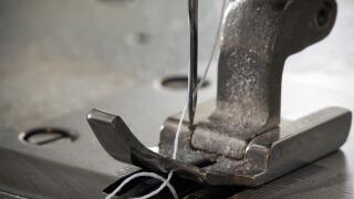 Industrial sewing machine's foot with thread and needle