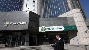 People walk past the Kuveyt Turk head office in Istanbul February 21, 2012. Turkey's government plans its first-ever issue of Islamic bonds this year, overcoming sensitivities about Islamic finance in the secular republic as it seeks to tap a rich pool of