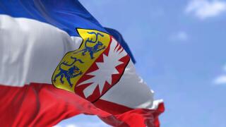 The flag of Schleswig-Holstein waving in the wind on a clear day