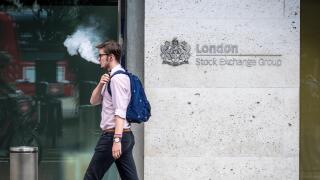London Stock Exchange LSE - A city worker exhales vapour while passing the London Stock Exchange offices in the City of London, UK