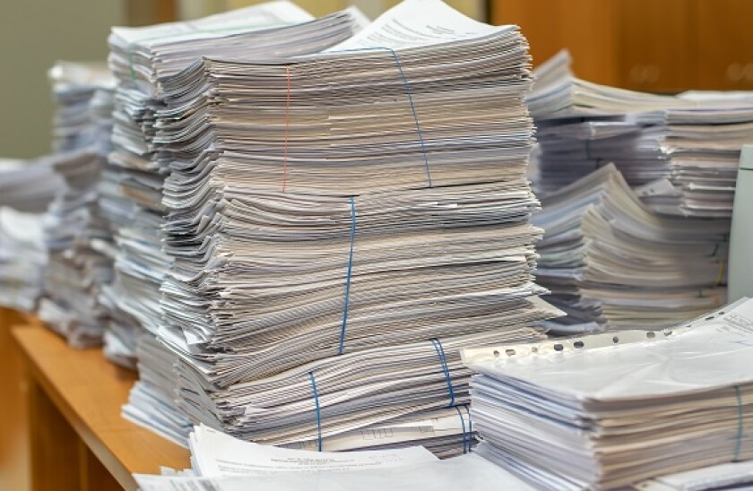 Desk_mess_documents_filing_575x375_Adobe_230120