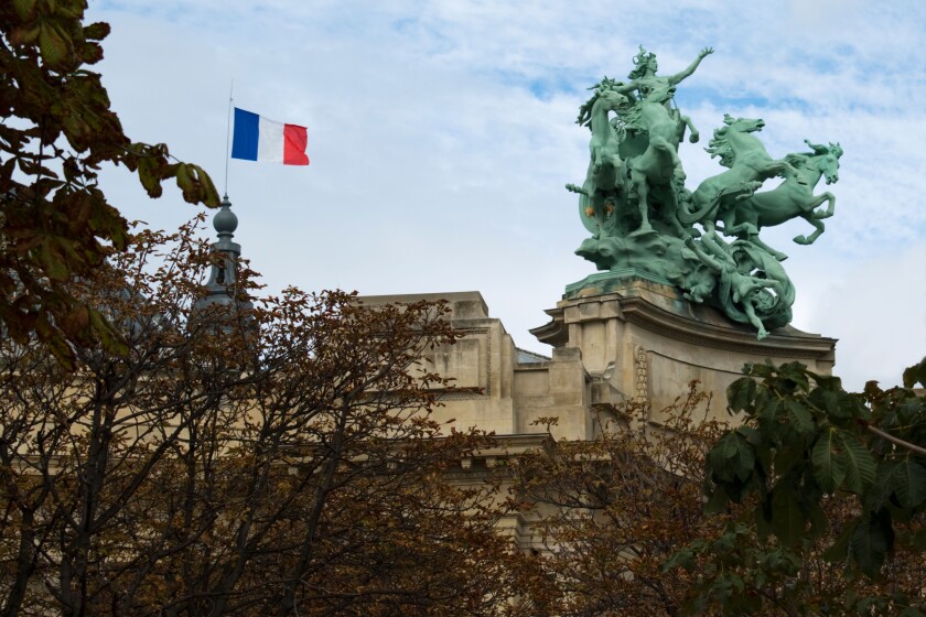 French flag and sculpture on the roof of Salon des Artistes Independants, Paris, France.