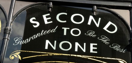 ' Second to None Guaranteed to be the Best ' sign on shop window