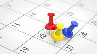 Busy day with several events concept with 3 colored push pins on a calendar page 3D illustration.