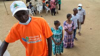 People wait in line near a vaccination truck to receive a vaccine against the coronavirus disease (COVID-19) during the visit of Sandra Kramer, director for Africa at the Directorate General for International Partnerships (INTPA) of the European Commissio