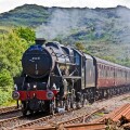 The Jacobite steam train approaches Arisaig railway station at Arisaig in the West Highlands of Scotland