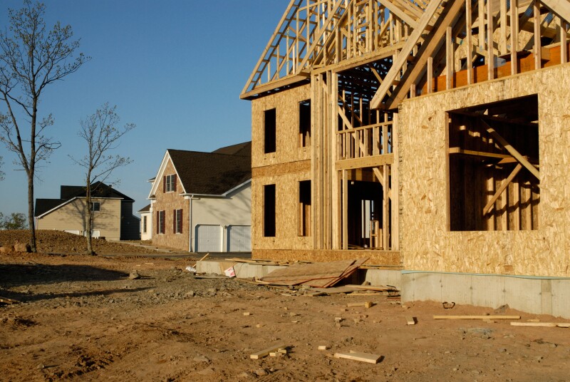 New suburban housing development under construction with finished and newly framed houses