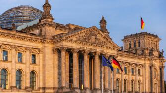 German Parliament the Bundestag in the Reichstag Building. Text says: To the German Population German Parliament the Bundestag in the Reichstag Buildi