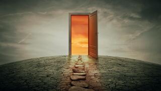 Pathway along a dry, cracked desert land, going to a opened door to another better and colorful world. Road of opportunity and success symbol. Another