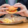 close up view of man's hands with american burger.