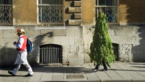 May morning May Day, The party is over by 9am. A Morris Man and his Green Man companion tired and wilting make their way home having probably been up all night celebrating. Oxford England UK. 1st May 2013 2010s HOMER SYKES