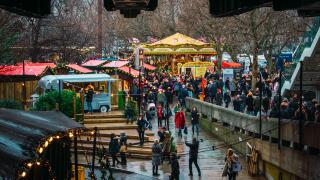 London, UK/Europe; 21/12/2019: Winter Christmas market in Southbank, London. People eating, drinking and having fun with friends and family.