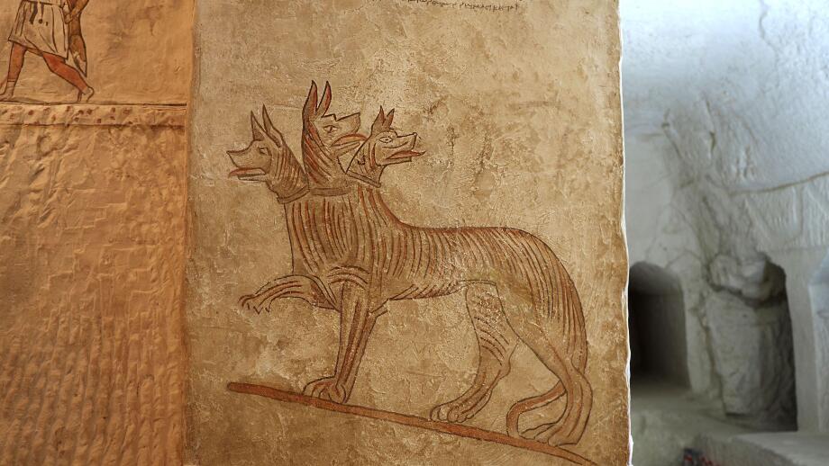 Mystical and ordinary animals on the wall in the family tomb in ancient city Maresha. Cerberus.