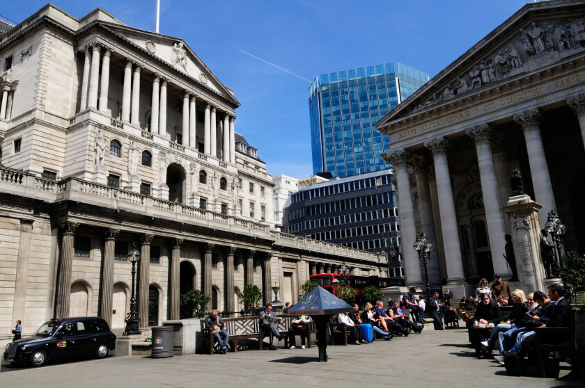 People eating lunch outside The Bank of England and The Royal Exchange, Threadneedle Street, London, England, UK