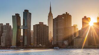 The Sun is shining through a Manhattan buildings in the New York City, US