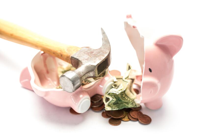 Piggy bank broken with money and hammer on white background