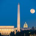 Supermoon above three iconic monuments: Lincoln Memorial, Washington Monument and Capitol Building in Washington DC as viewed from Arlington, Virginia