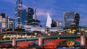 Southwark - London, England. The lights come on along Southwark Bridge at dusk. Crossing the River Thames between Southwark and the City, the arched b