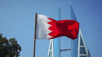 The national flag of Bahrain and Bahrain World Trade Centre.f