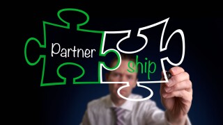 A businessman drawing a Partnership Puzzle Concept.