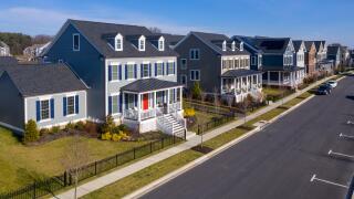 Aerial view of typical upper class American single family real estate homes with vinyl siding and brick facade in the East Coast of the United States