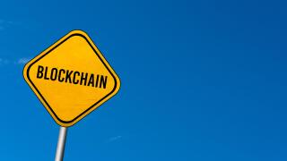 Blockchain - yellow sign with blue sky