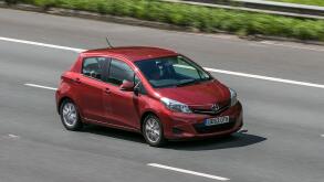 A 2013 Toyota Yaris Tr Vvt-I Red Car Hatchback Petrol driving on the M6 motorway near Preston in Lancashire, UK