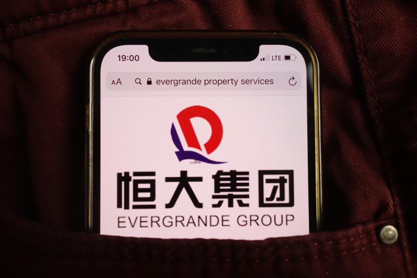 KONSKIE, POLAND - August 17, 2021: Evergrande Group logo on mobile phone hidden in jeans pocket