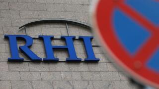 The logo of Austrian specialised fireproof materials maker RHI is pictured behind a traffic sign at an office park building where its headquarters are located in Vienna, Austria October 6, 2016. REUTERS/Heinz-Peter Bader